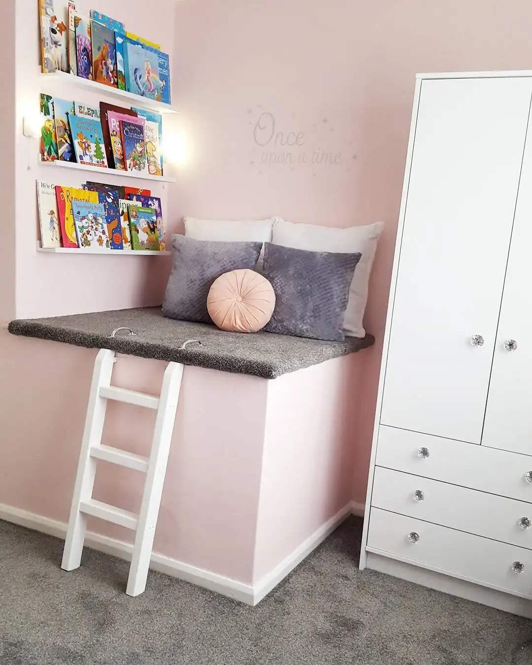 Small kids bedroom with cushioned reading perch on a raised corner platform and wall book ledges